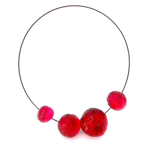 Collier composé de 4 sphères de résine rouge, fermoir aimanté.
